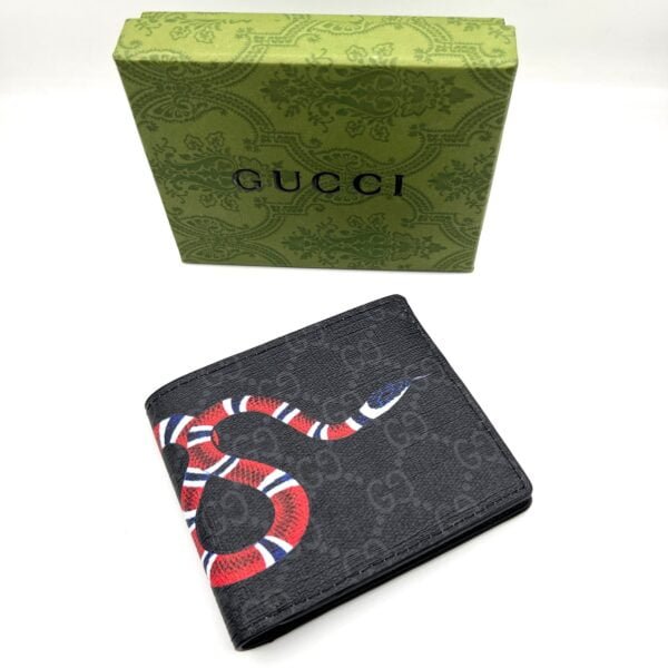 Black Gucci wallet featuring a colorful snake design on the front, placed against a white background. The wallet is a premium designer accessory